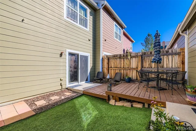a view of a house with backyard and sitting area