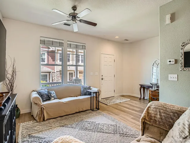 a bedroom with a bed couch and a window
