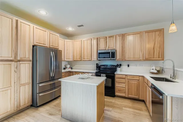a kitchen with a refrigerator sink and microwave