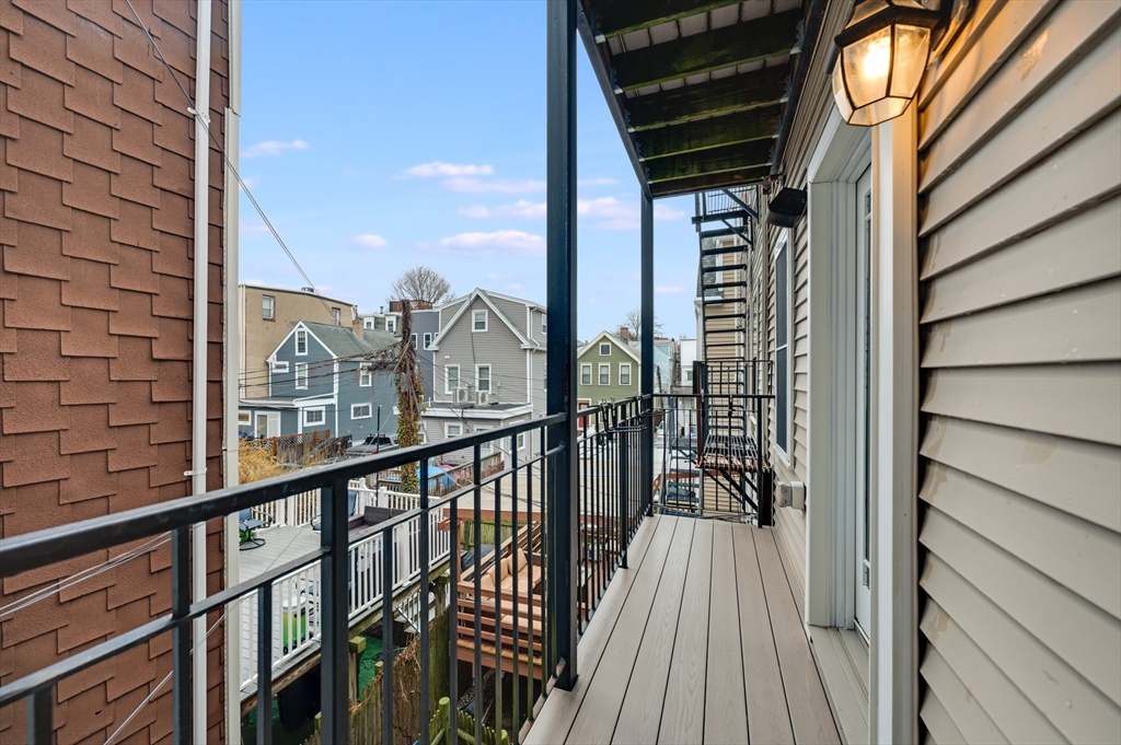 504 East 8th Street, Unit 2 Boston, MA 02127 - Photo 12 of 13 a view of a balcony with floor to ceiling windows with wooden floor