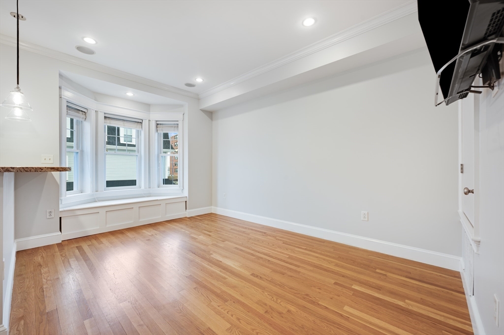 504 East 8th Street, Unit 2 Boston, MA 02127 - Photo 3 of 13 wooden floor in an empty room with a window