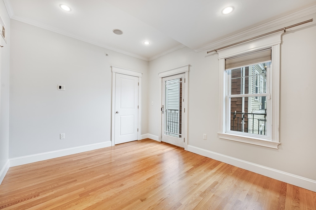 504 East 8th Street, Unit 2 Boston, MA 02127 - Photo 8 of 13 a view of empty room with wooden floor and fan