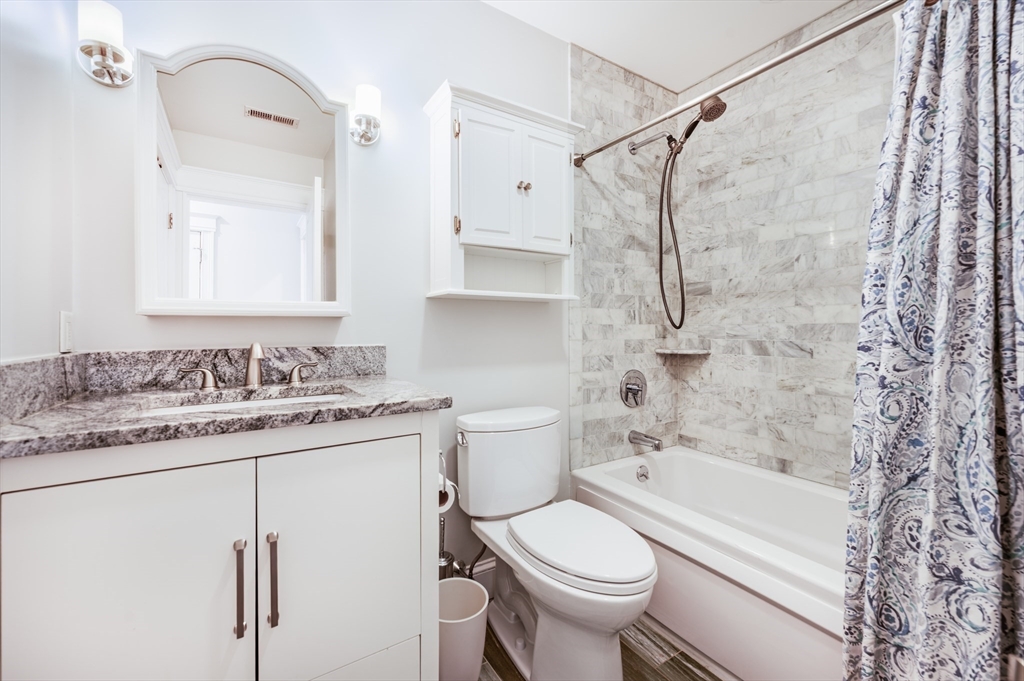 504 East 8th Street, Unit 2 Boston, MA 02127 - Photo 10 of 13 a bathroom with a granite countertop sink toilet and shower