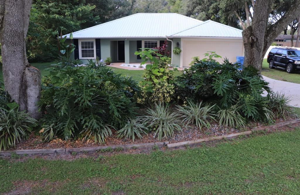 2016 Florida Street Valrico, FL 33594 - Photo 1 of 1 a front view of a house with a garden