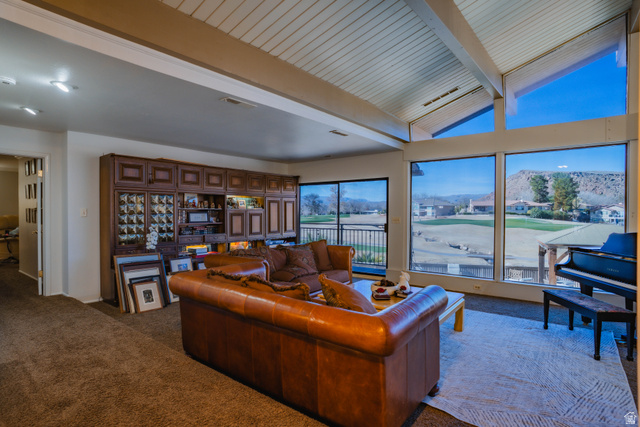 980 Cactus Circle St. George, UT 84790 - Photo 13 of 77 Living area featuring carpet, vaulted ceiling with beams, and golf course view