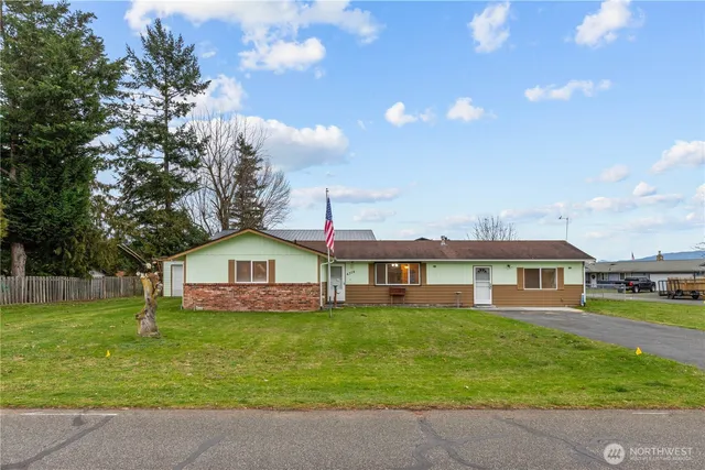 a front view of house with yard and green space