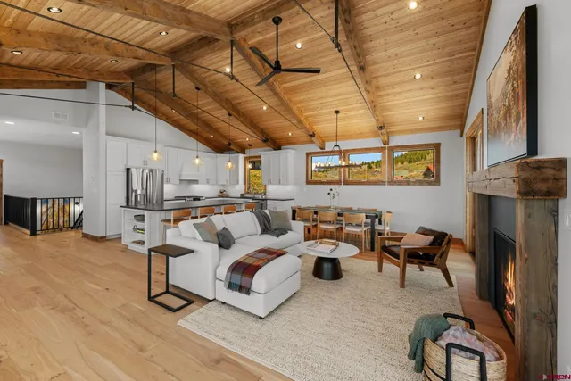 a living room with furniture and a chandelier