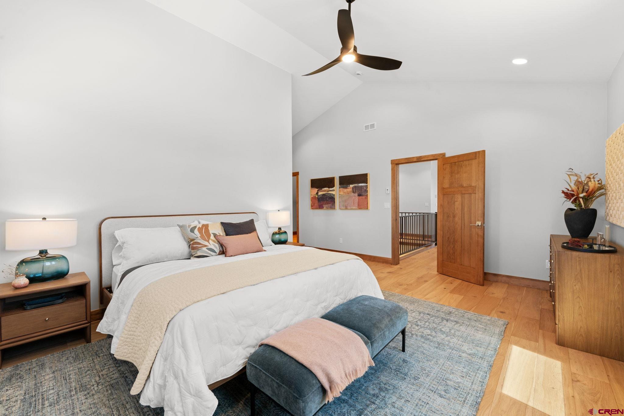 64 Buckhorn Way Crested Butte, CO 81224 - Photo 17 of 45 a spacious bedroom with a bed and wooden floor