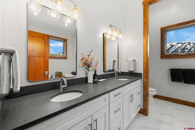 a bathroom with a double vanity sink and a mirror