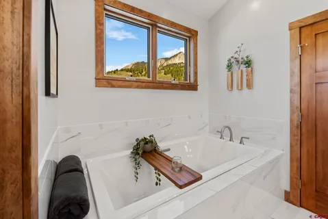 a bathroom with a tub and a sink