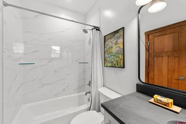 a bathroom with a tub shower and sink