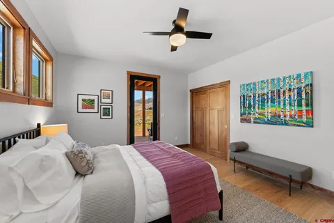 a bedroom with a bed a dresser and a window