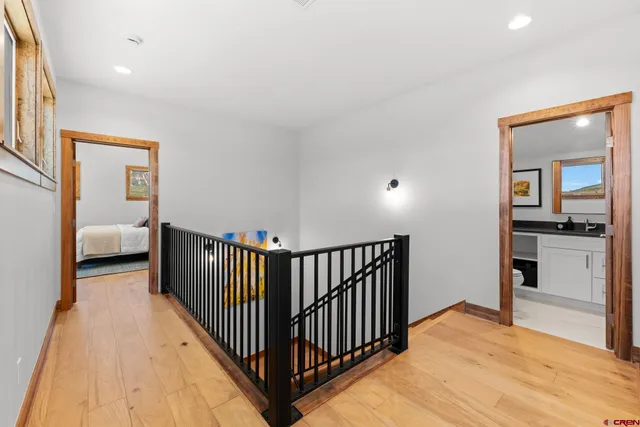 a view of a bedroom with wooden floor & a bedroom