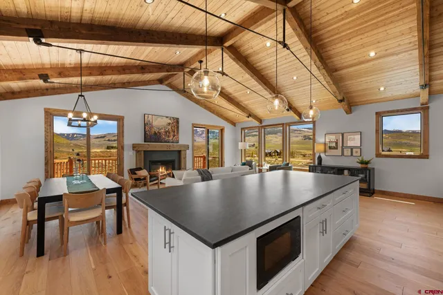a kitchen with sink and chairs