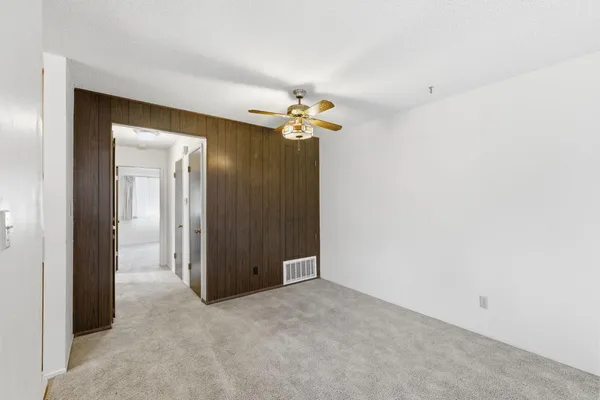 a view of a chandelier fan and entryway