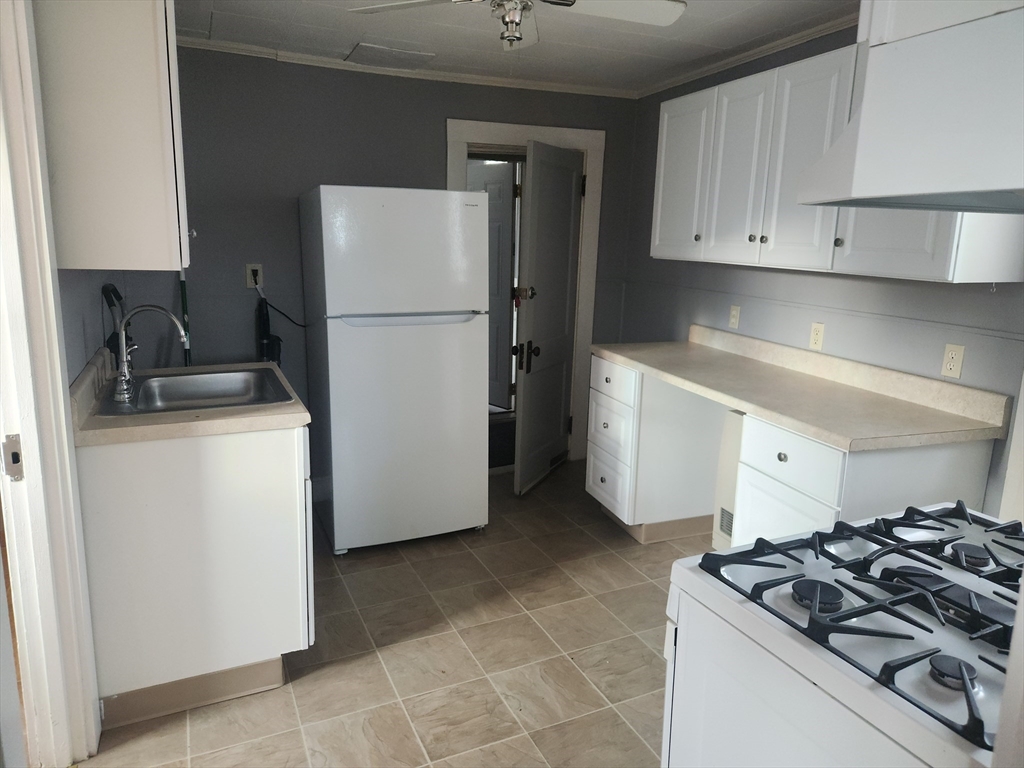 68 Beach Road, Unit 2 Winthrop, MA 02152 - Photo 3 of 4 a kitchen with a refrigerator and a stove