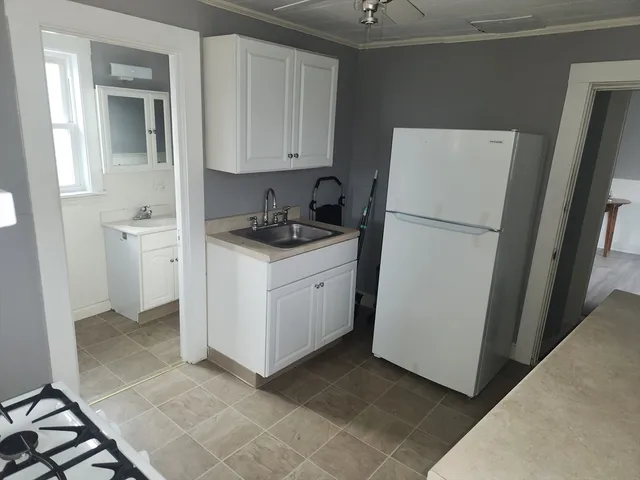 a utility room with cabinets washer and dryer