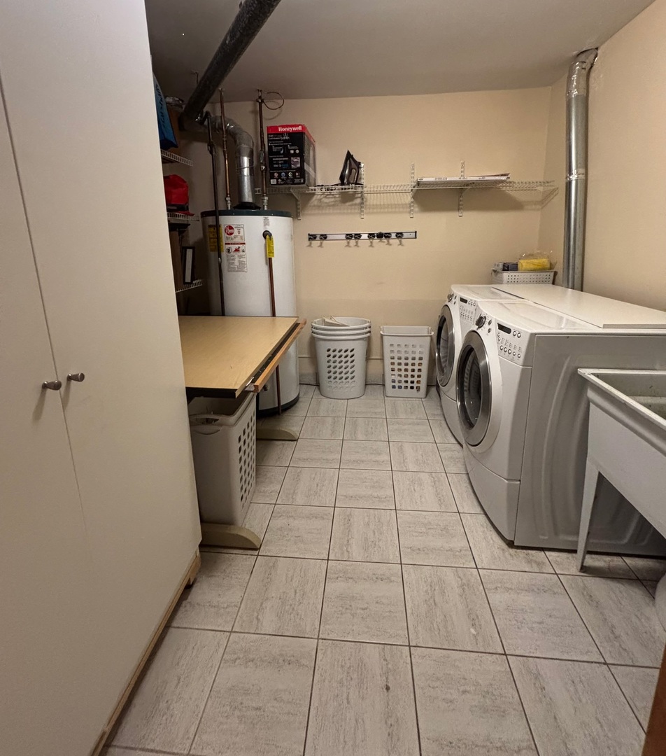 2350 North Sayre Avenue, Unit G Chicago, IL 60707 - Photo 22 of 30 a utility room with cabinets dryer and washer