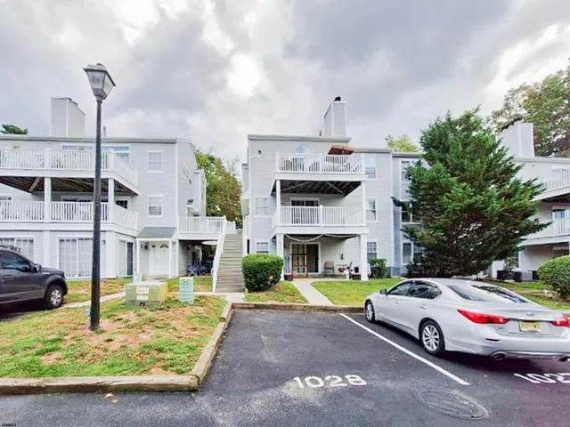 a view of building with cars parked infront