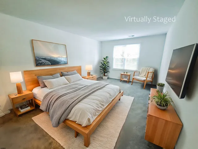 a bedroom with bed and a flat screen tv