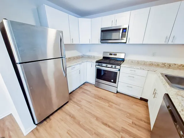 a kitchen with a refrigerator sink and microwave