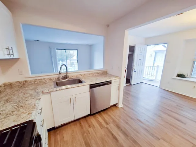 a kitchen with wooden floors and sink