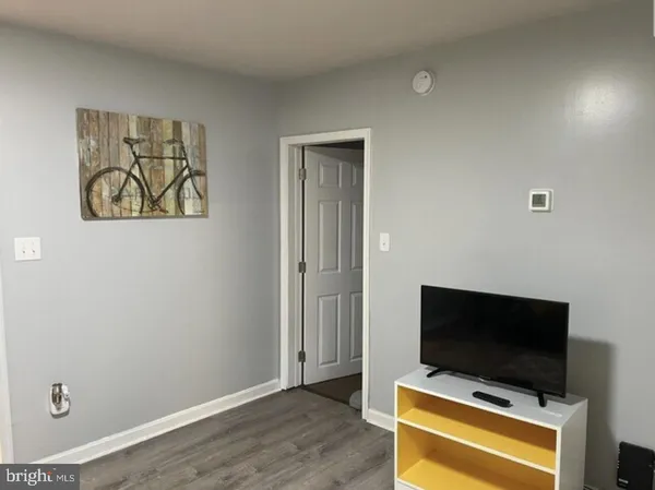 a room with a flat screen tv and a window