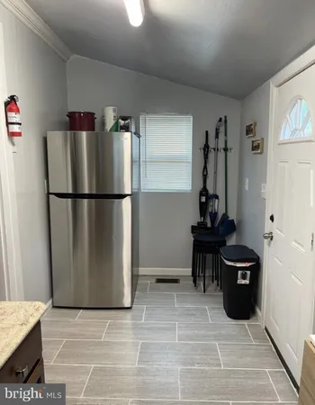 a kitchen with a refrigerator and a stove