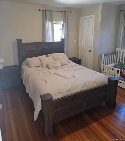 a bed sitting in a bedroom next to a window