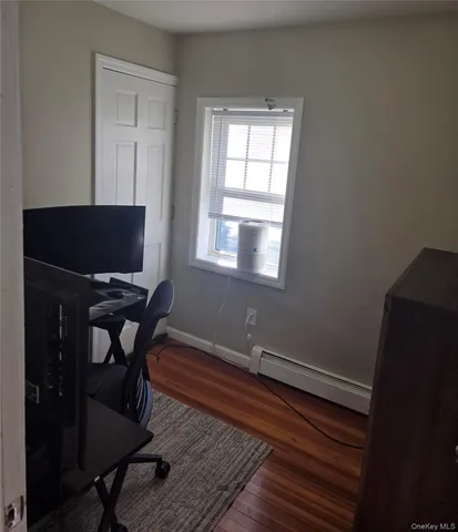 a workspace with wooden floor and a window
