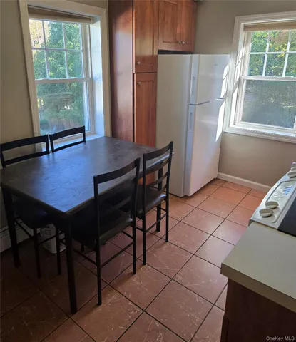 a view of a room with a window and wooden floor