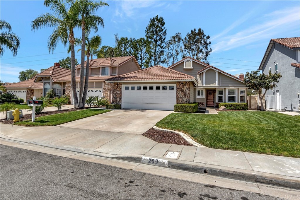 259 South Raspberry Lane Anaheim Hills, CA 92808 - Photo 1 of 1 a front view of a house with a yard and garage