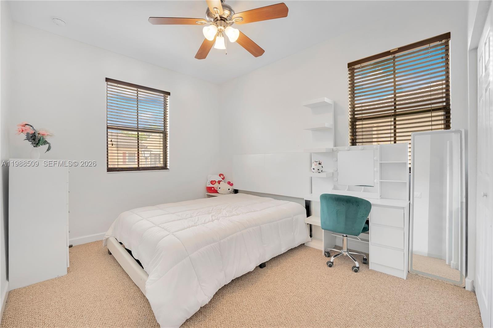 23484 Southwest 112th Court Homestead, FL 33032 - Photo 12 of 33 a bedroom with a bed and a chair