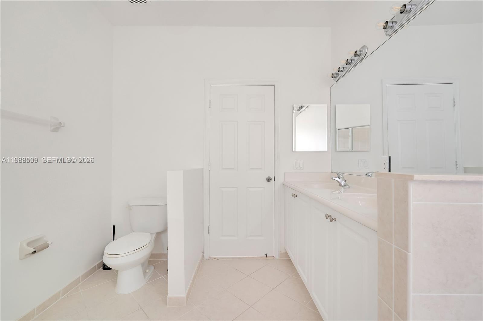 23484 Southwest 112th Court Homestead, FL 33032 - Photo 16 of 33 a bathroom with a double vanity sink toilet and a tub