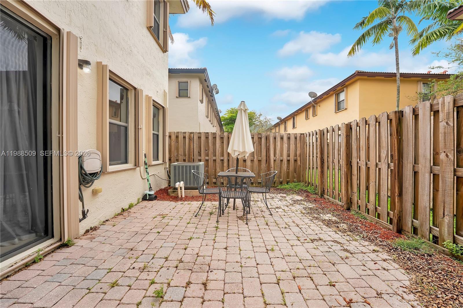 23484 Southwest 112th Court Homestead, FL 33032 - Photo 23 of 33 a building outdoor space with patio furniture and potted plants