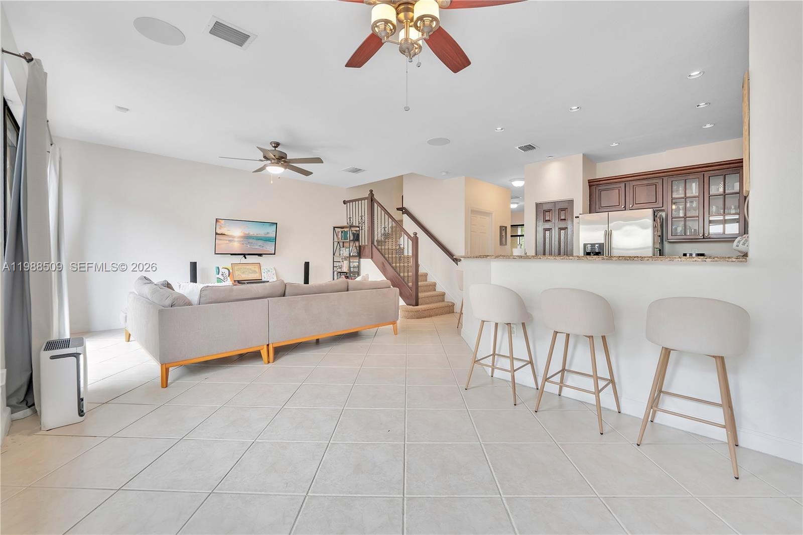 23484 Southwest 112th Court Homestead, FL 33032 - Photo 4 of 33 a living room with furniture and a chandelier