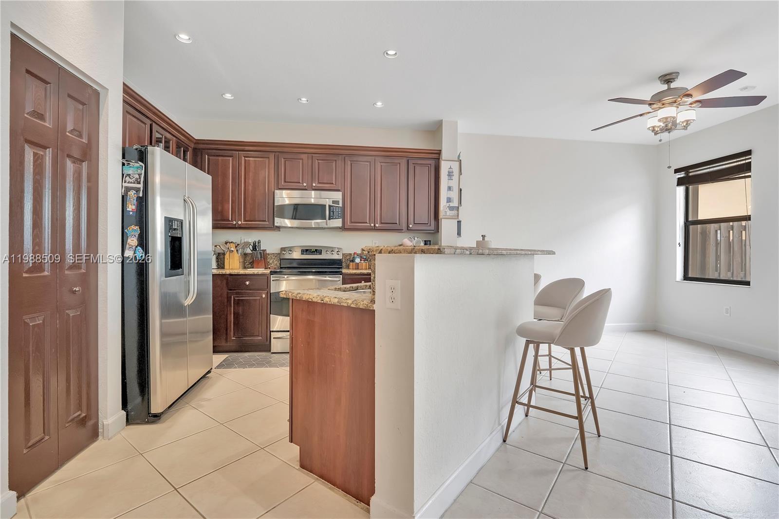 23484 Southwest 112th Court Homestead, FL 33032 - Photo 8 of 33 a kitchen with stainless steel appliances granite countertop a refrigerator and a stove top oven
