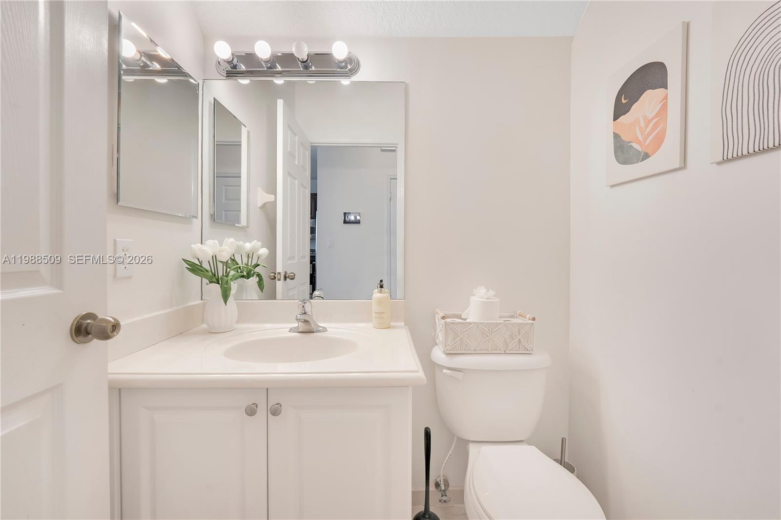 23484 Southwest 112th Court Homestead, FL 33032 - Photo 9 of 33 a bathroom with a sink a toilet and a mirror