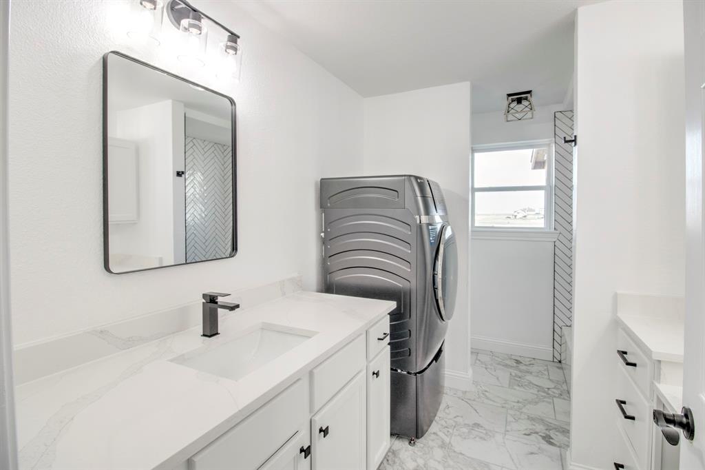 3884 Lois Road East Sanger, TX 76266 - Photo 26 of 40 a bathroom with a sink vanity and mirror