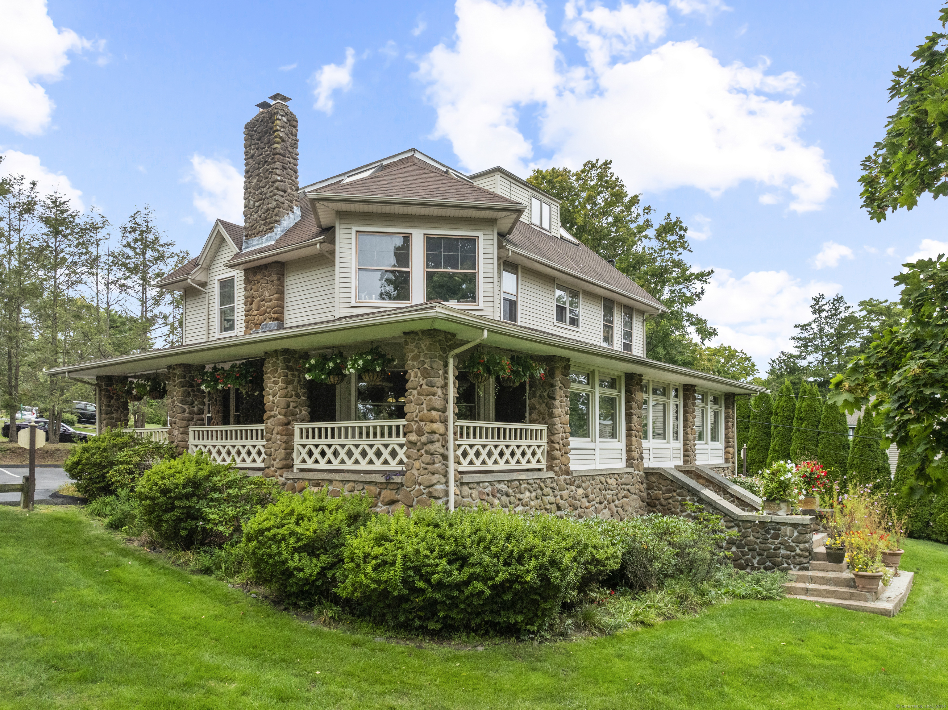 2750 Whitney Avenue Hamden, CT 06518 - Photo 1 of 1 a front view of a house with a garden