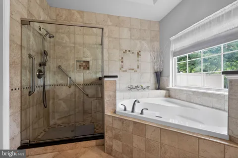 a bathroom with a bathtub and shower