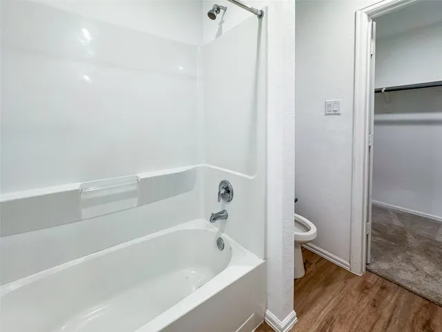 a bathroom with a bathtub and toilet