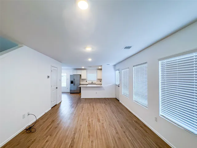 a view of a kitchen with wooden floor