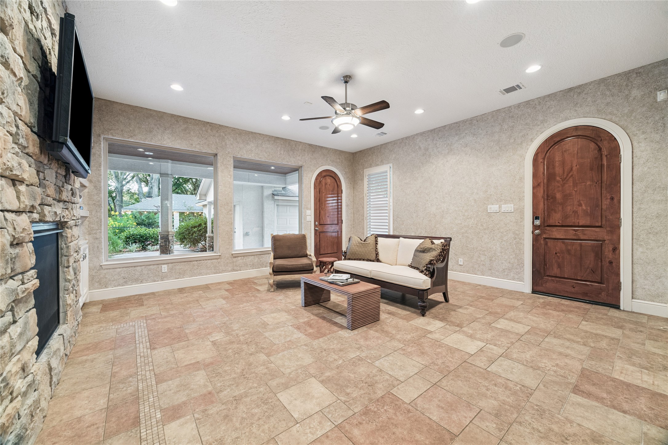 16218 Barklea Road Cypress, TX 77429 - Photo 11 of 36 a living room with furniture a fireplace and a flat screen tv