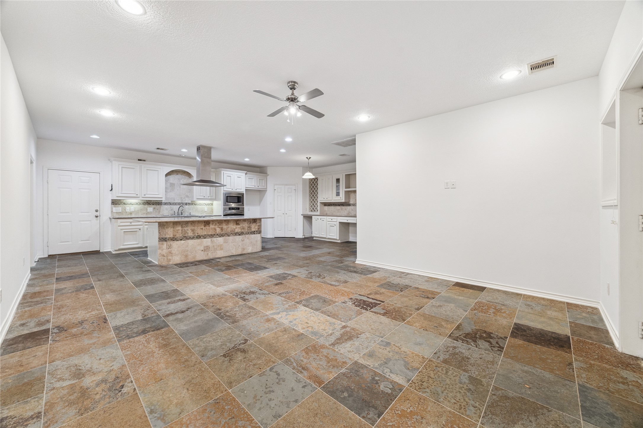 16218 Barklea Road Cypress, TX 77429 - Photo 16 of 36 a large white kitchen with kitchen island a stove a sink and a refrigerator