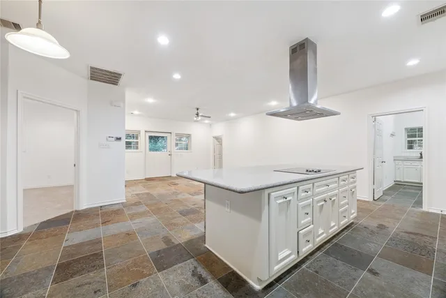 a view of kitchen with granite countertop cabinets and outdoor view
