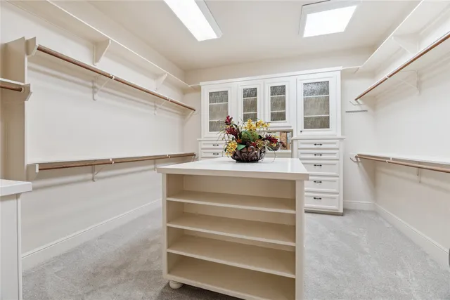 a view of an empty room with a kitchen