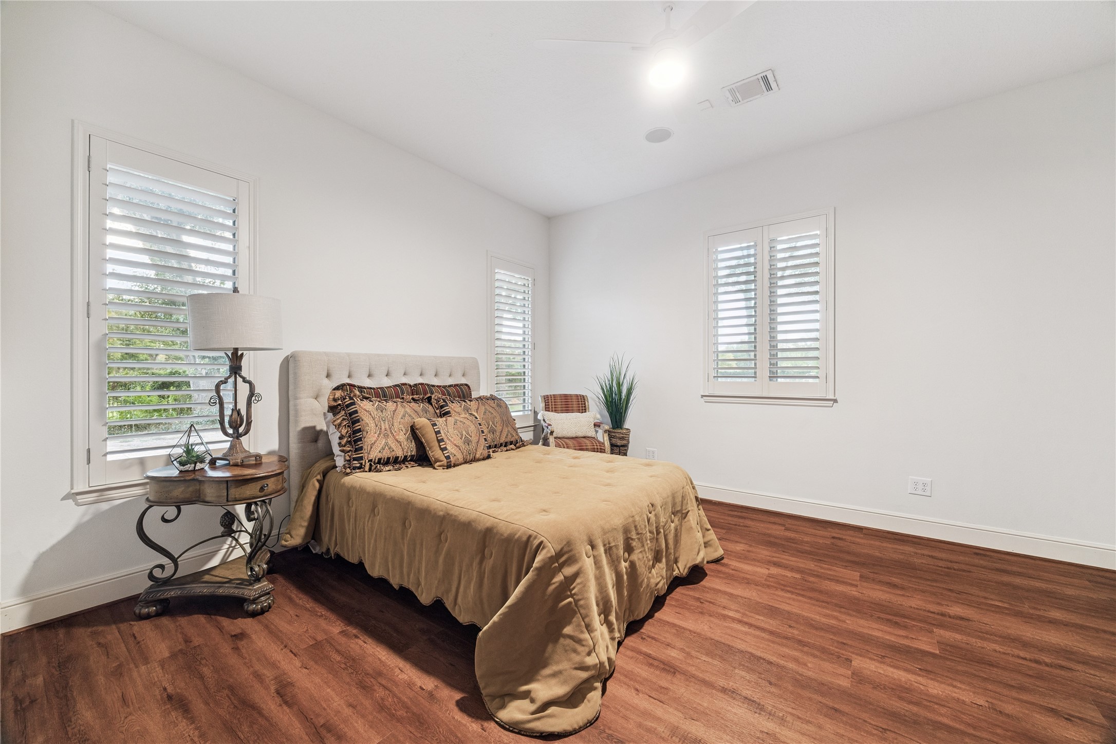 16218 Barklea Road Cypress, TX 77429 - Photo 26 of 36 a bedroom with a bed and wooden floor