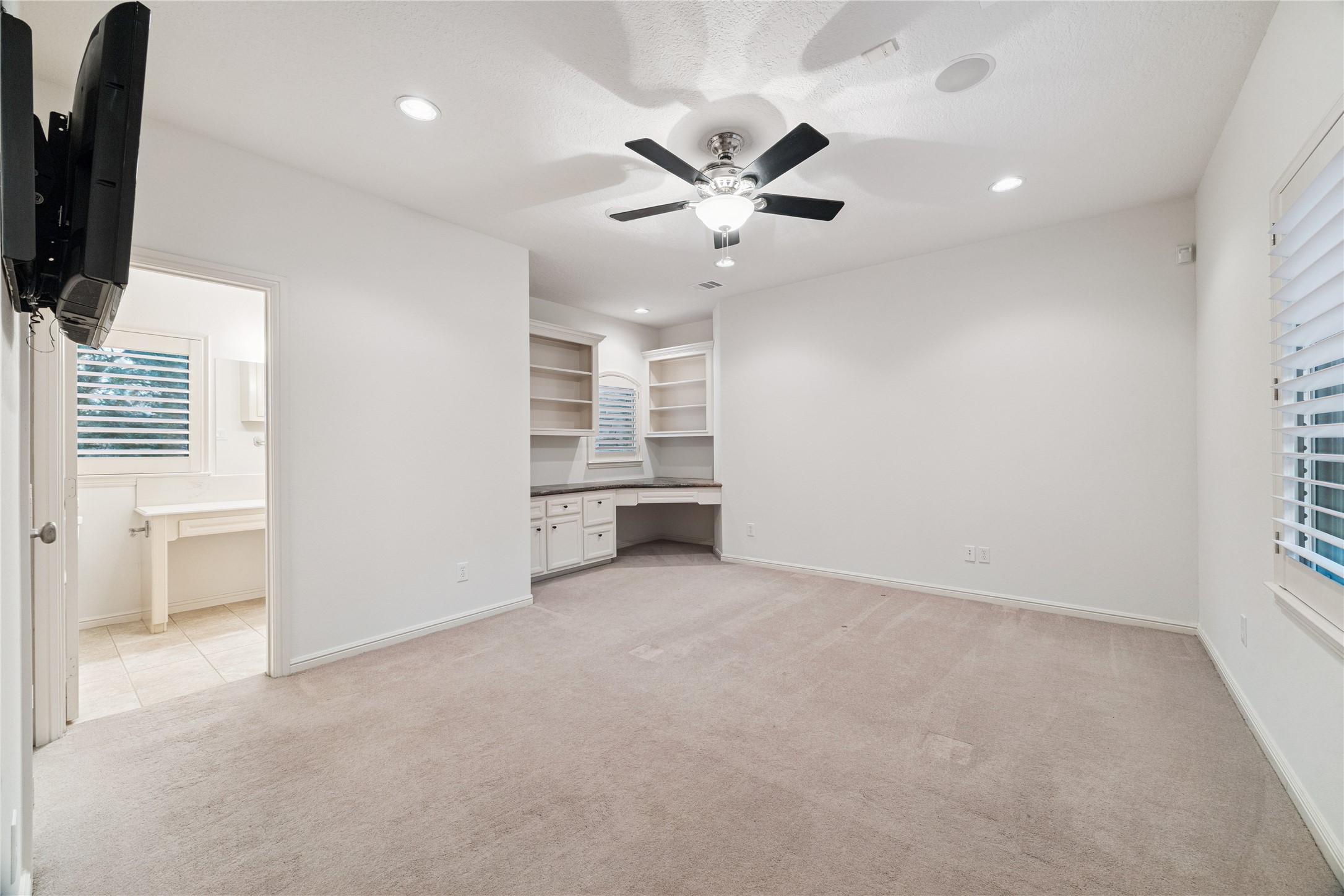 16218 Barklea Road Cypress, TX 77429 - Photo 27 of 36 an empty room with windows and cabinet