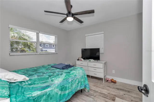 a bedroom with a bed and a flat screen tv